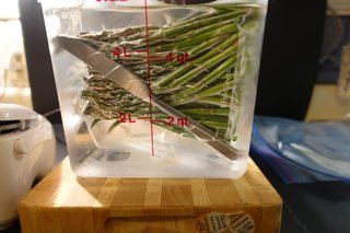 Bag of asparagus weighted with a butter knife